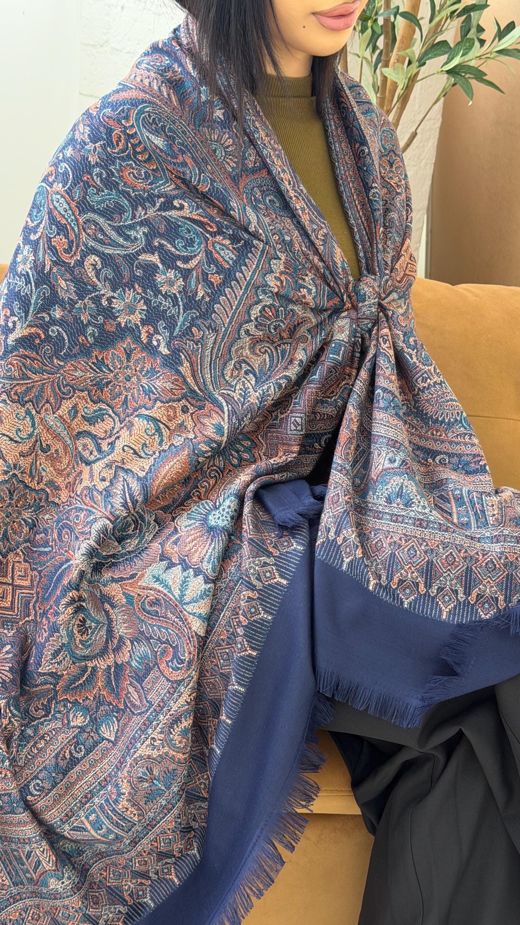 Person wearing a blue pashmina patterned shawl 