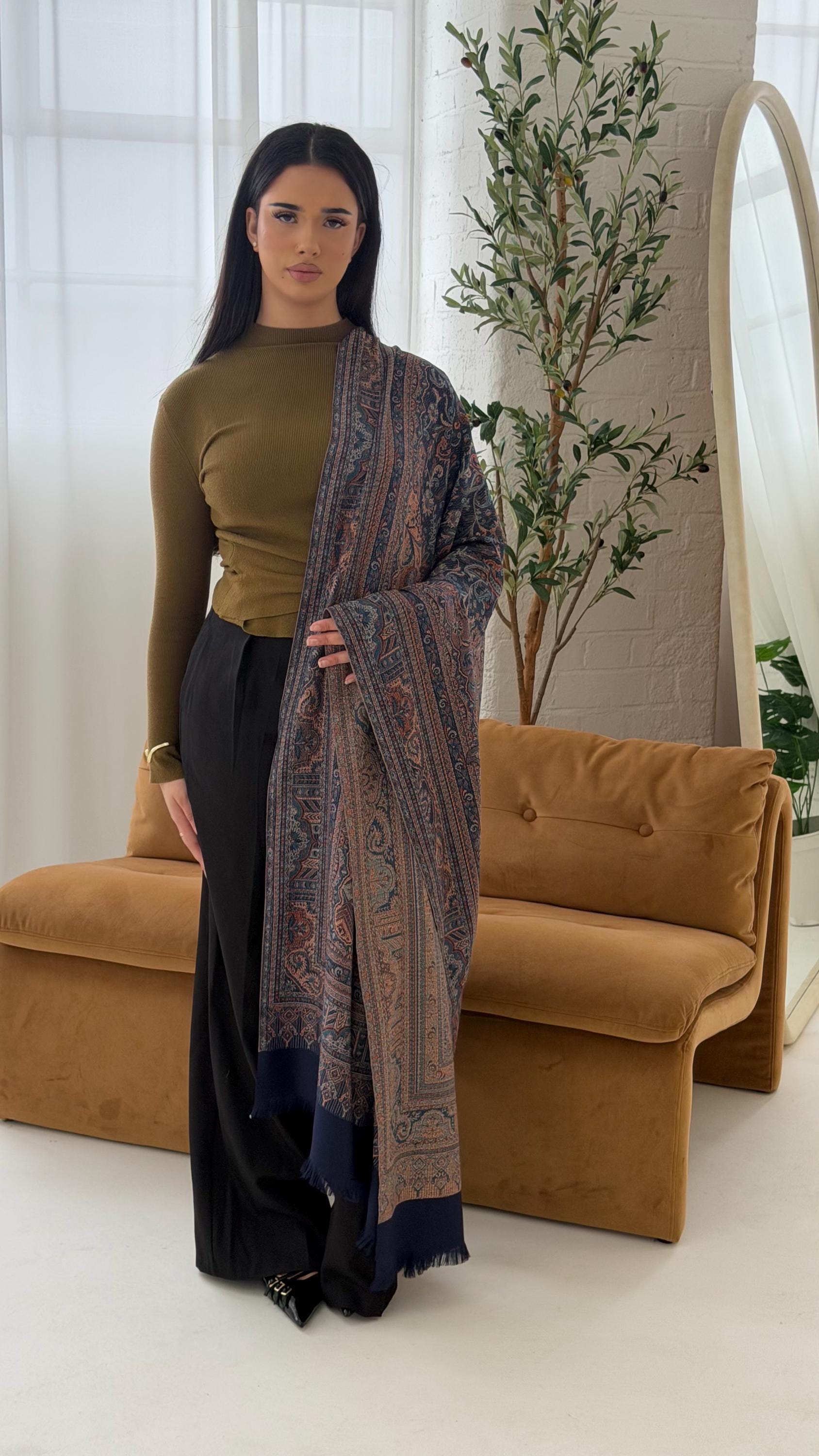Woman holding a blue scarf in a living room setting