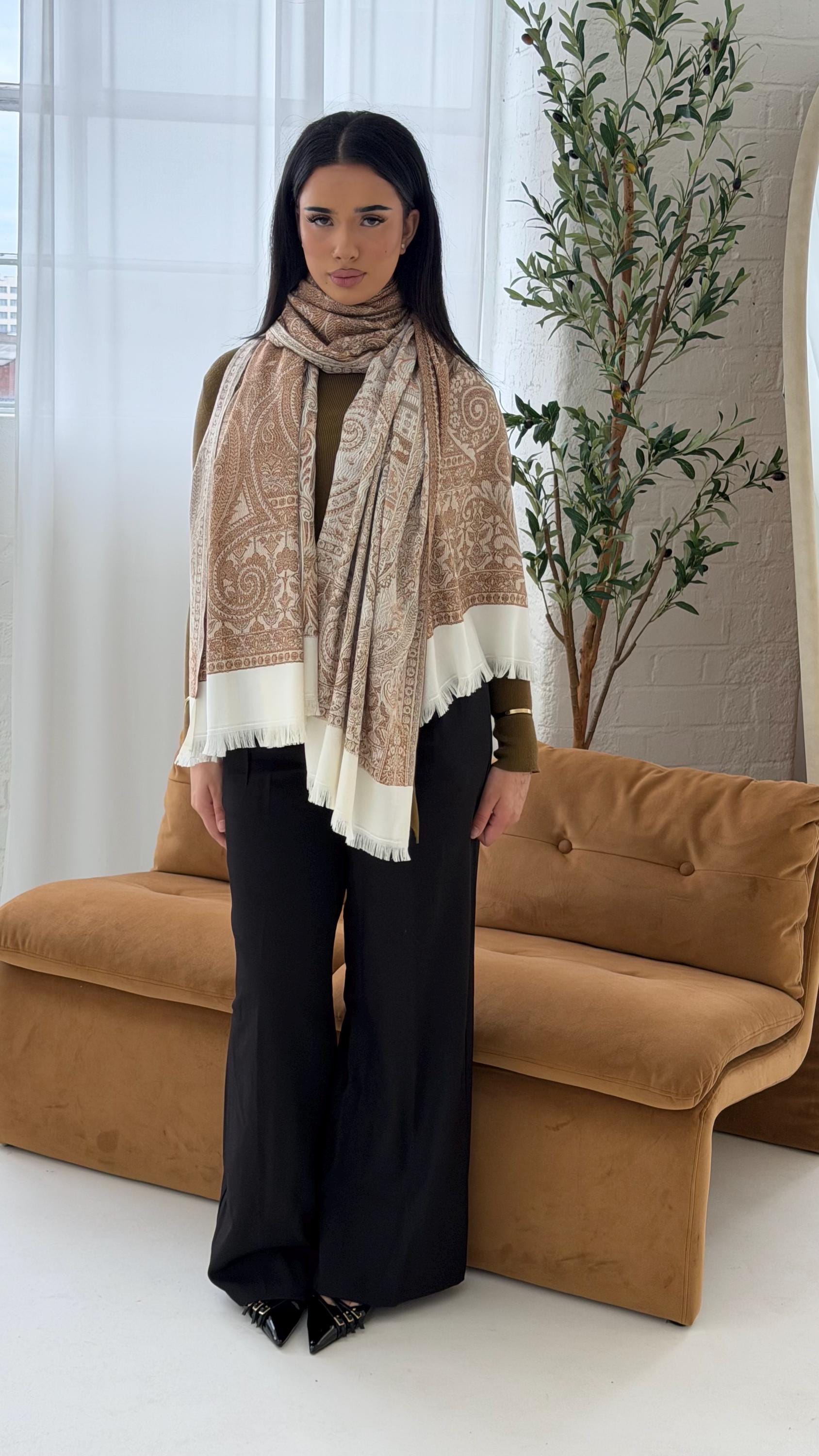 Woman wearing a patterned scarf in a living room setting