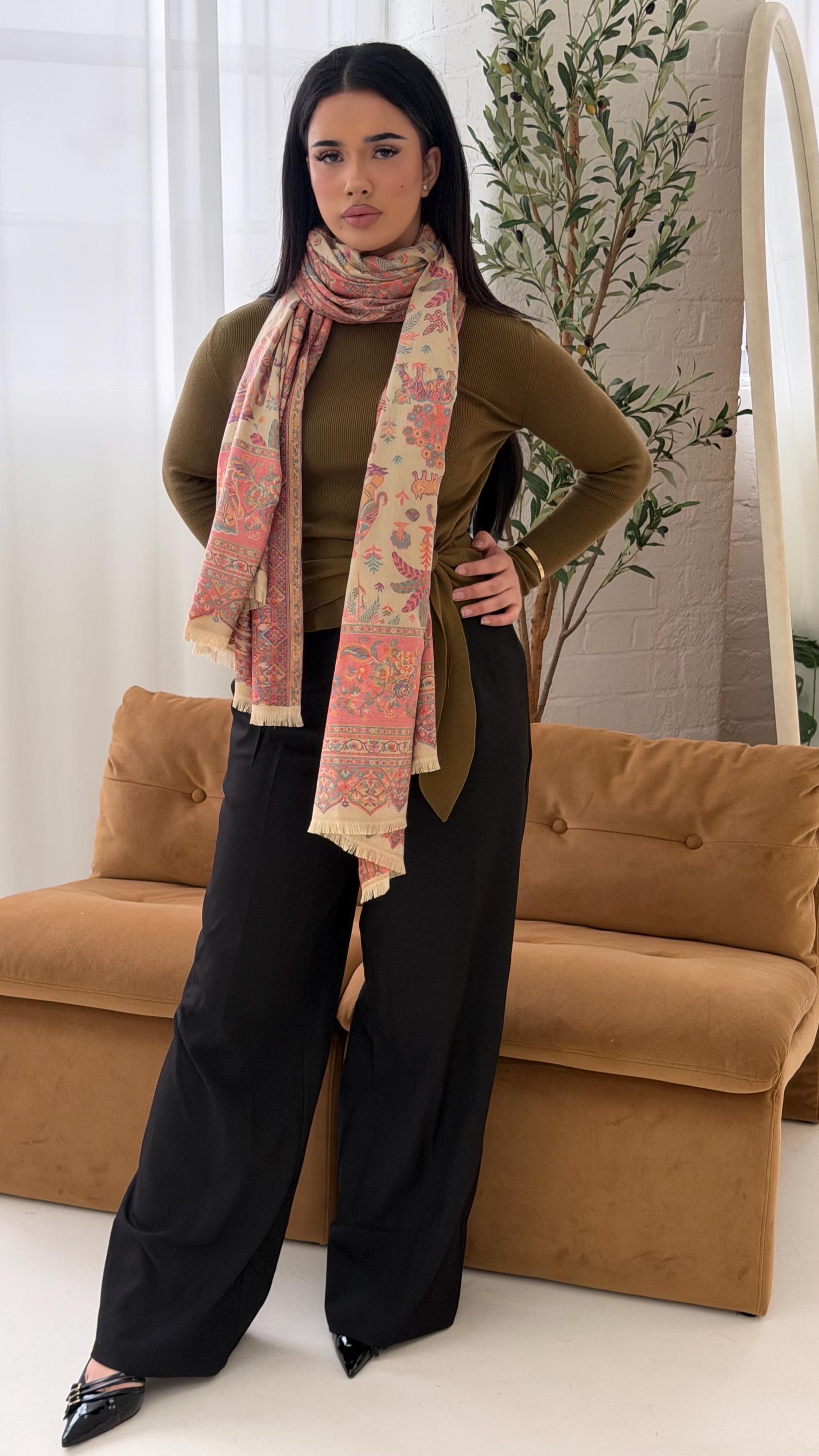 Woman wearing a beige patterned pashmina shawl  in a living room setting