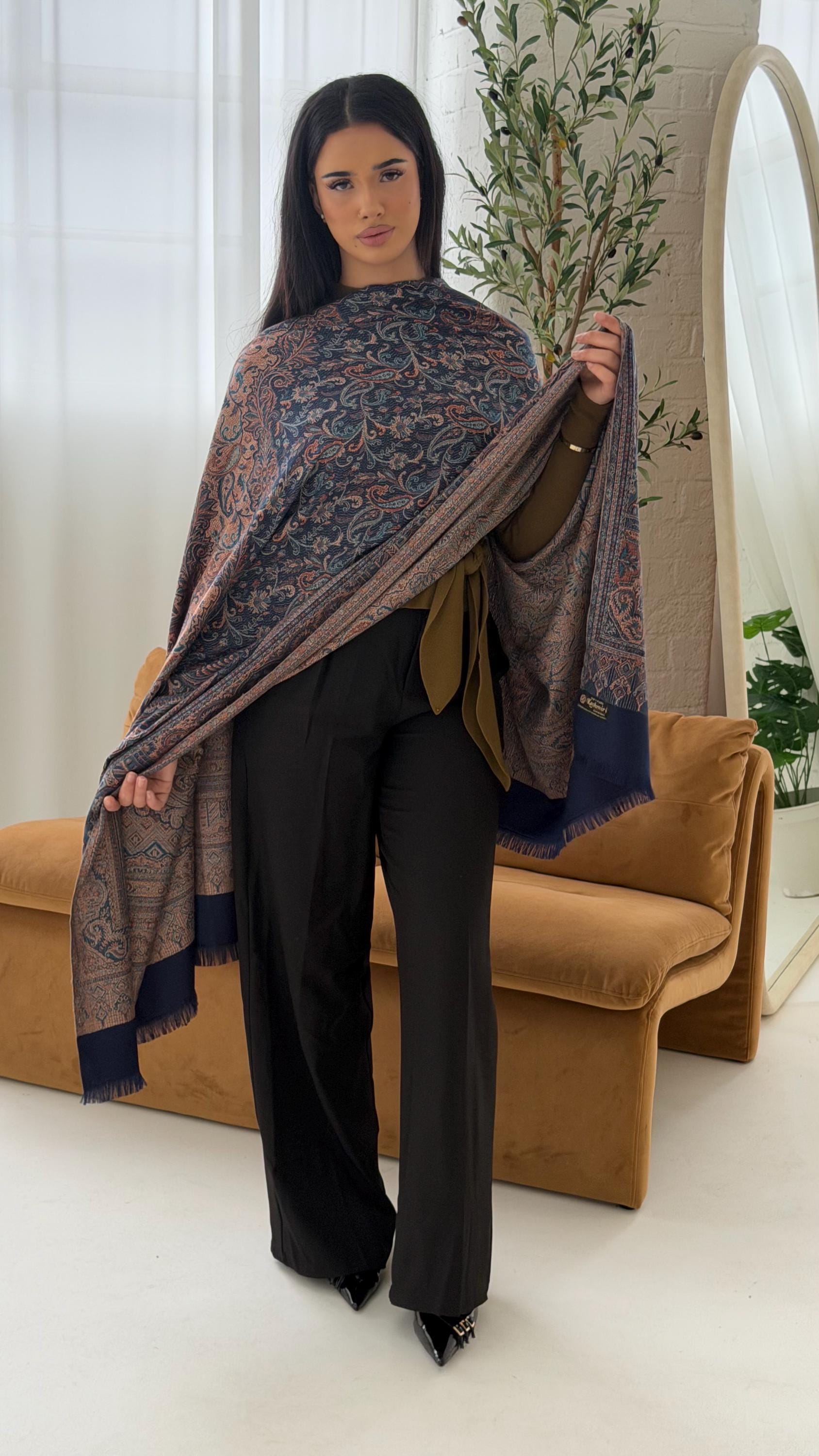 Woman holding a blue shawl in a living room setting